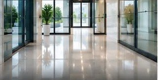 A polished commercial lobby with glass entrance doors